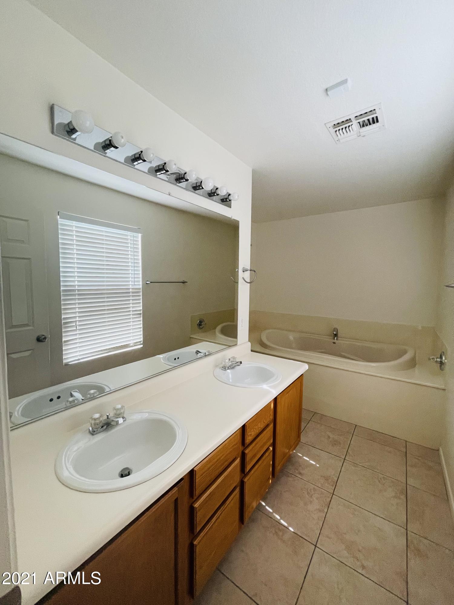 10642 East Arbor Avenue Mesa, AZ 85120 - Photo 8 of 12 a bathroom with a sink and a bathtub