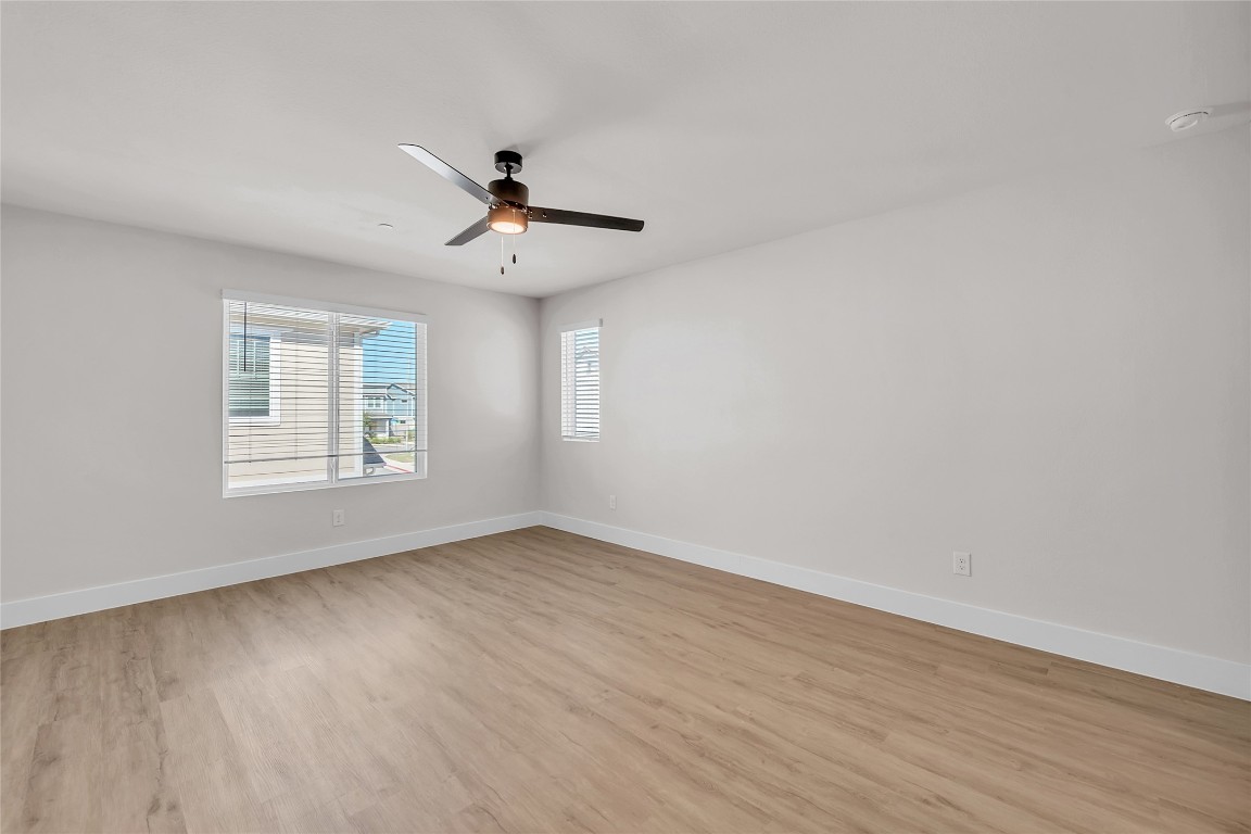 7600 Strong Bow Court Austin, TX 78744 - Photo 13 of 26 Spare room with light wood-type flooring and a ceiling fan