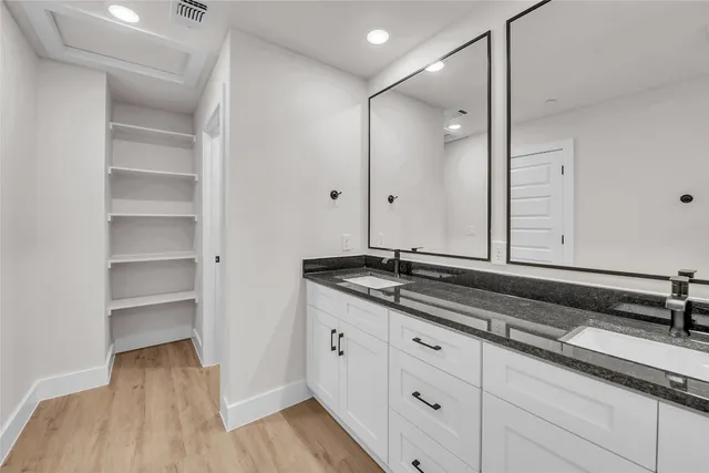 a bathroom with a shower sink and mirror