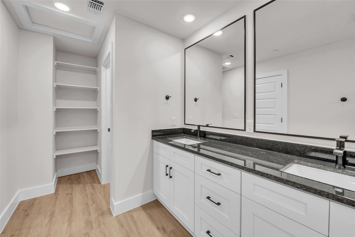 7600 Strong Bow Court Austin, TX 78744 - Photo 15 of 26 Bathroom featuring double vanity, light wood finished floors, and recessed lighting