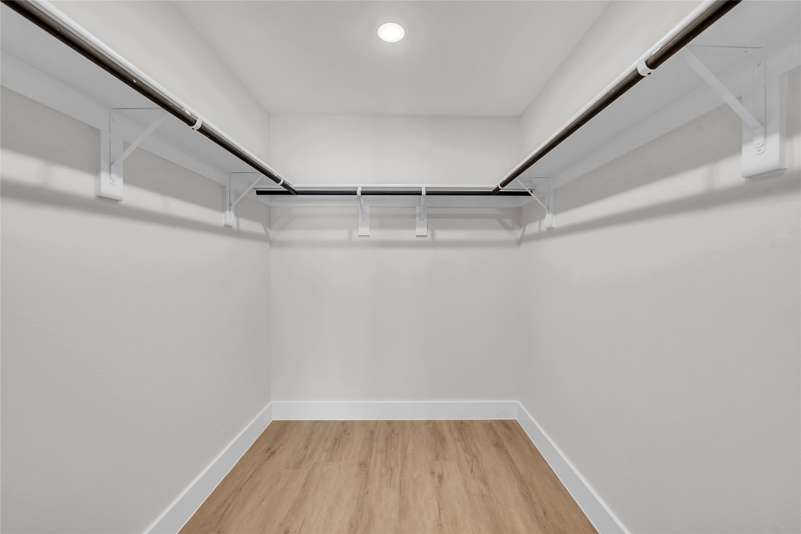 7600 Strong Bow Court Austin, TX 78744 - Photo 16 of 26 Walk in closet featuring light wood-type flooring
