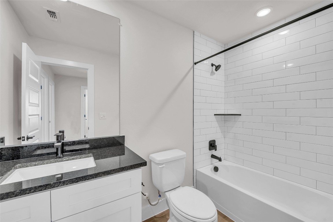 7600 Strong Bow Court Austin, TX 78744 - Photo 21 of 26 Full bath featuring shower / washtub combination, vanity, and recessed lighting