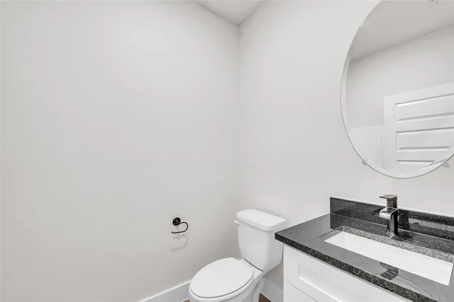 a kitchen with stainless steel appliances granite countertop a sink a stove and refrigerator