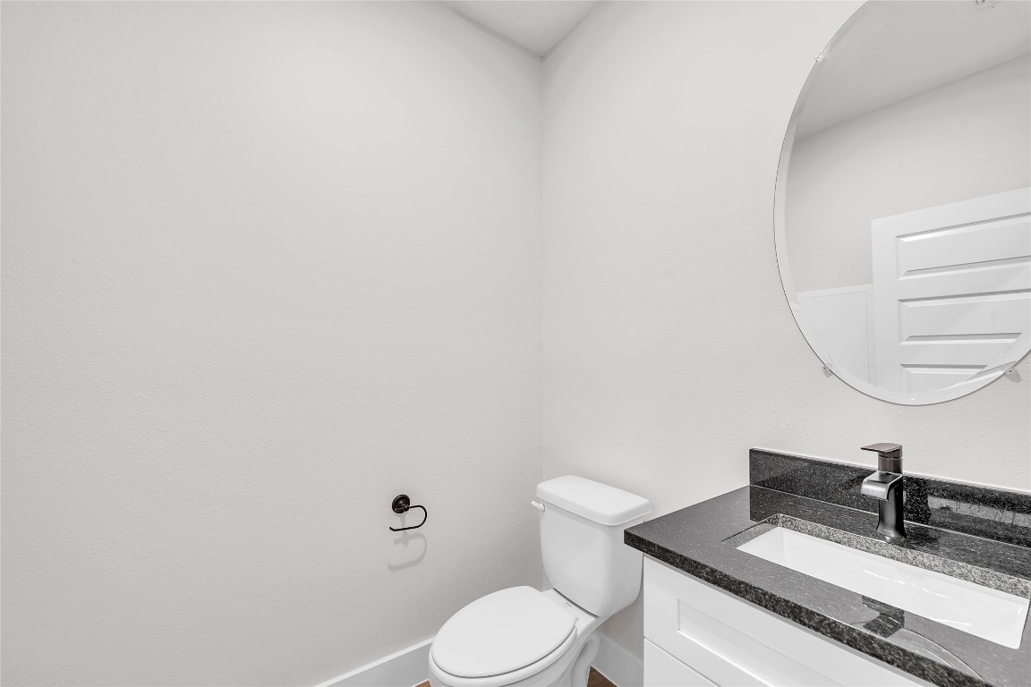 7600 Strong Bow Court Austin, TX 78744 - Photo 9 of 26 Bathroom with vanity and toilet