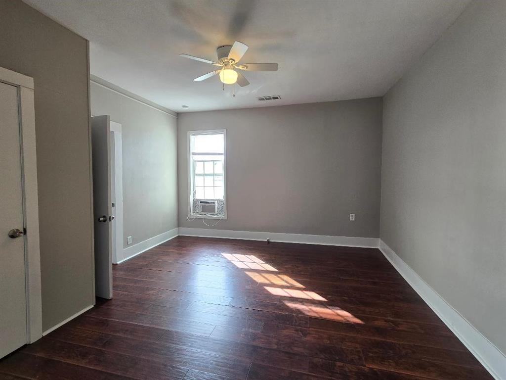 114 South 20th Street Corsicana, TX 75110 - Photo 11 of 15 an empty room with wooden floor and window