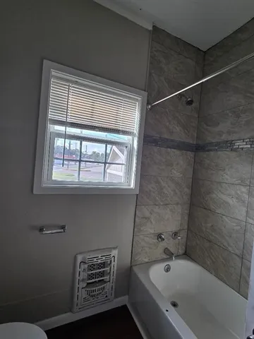 a bathroom with a bathtub and a shower