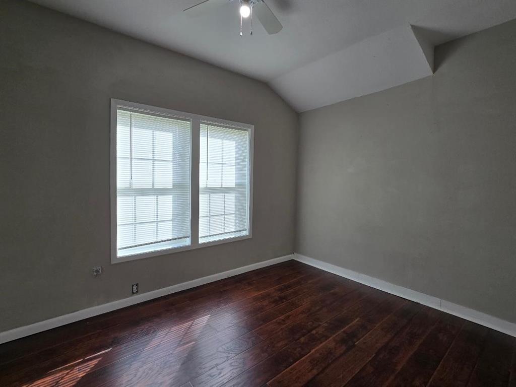 114 South 20th Street Corsicana, TX 75110 - Photo 14 of 15 an empty room with wooden floor and windows