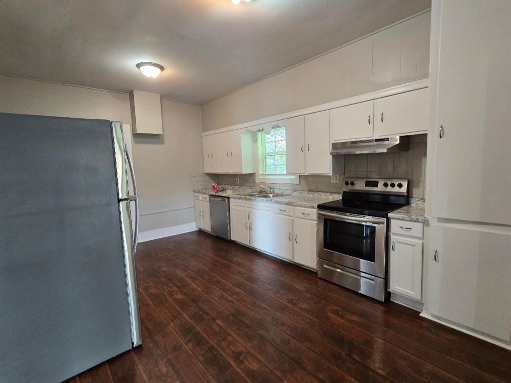 114 South 20th Street Corsicana, TX 75110 - Photo 5 of 15 a kitchen with a refrigerator and a stove top oven