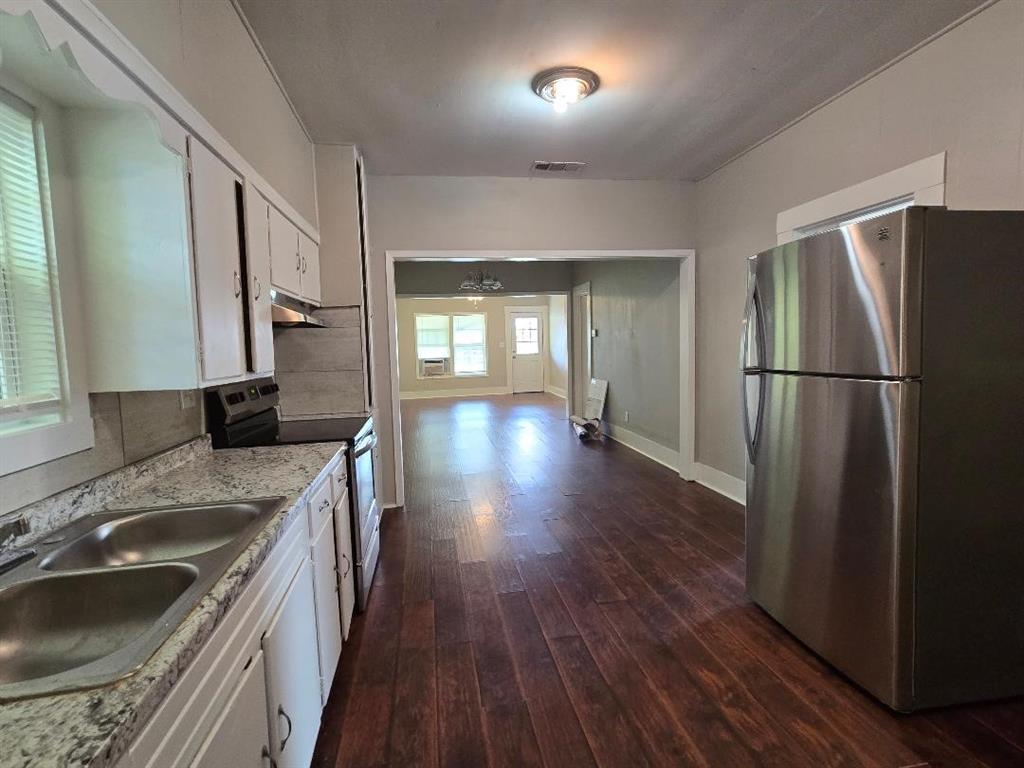 114 South 20th Street Corsicana, TX 75110 - Photo 6 of 15 a kitchen with a refrigerator sink and wooden floor