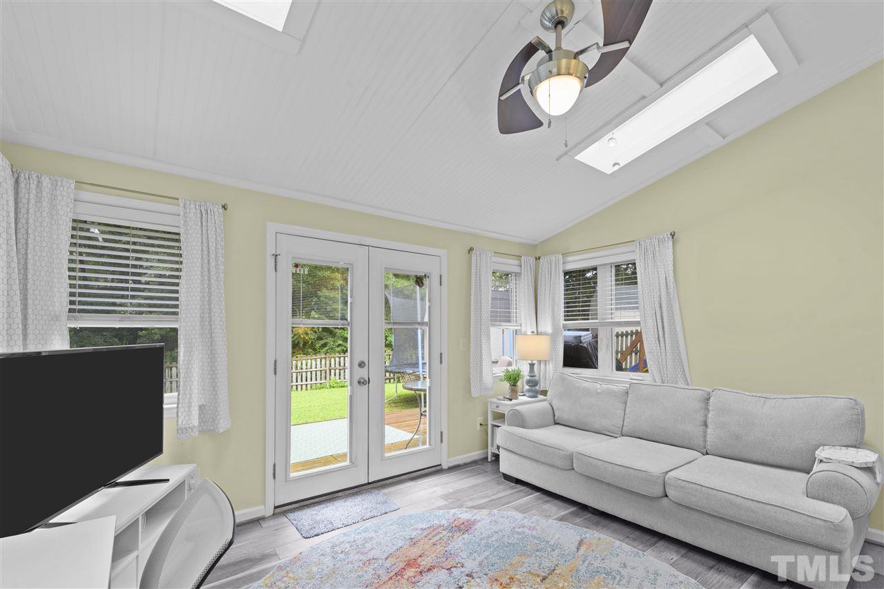 7050 Jeffreys Creek Lane Raleigh, NC 27616 - Photo 11 of 23 a living room with furniture and a floor to ceiling window