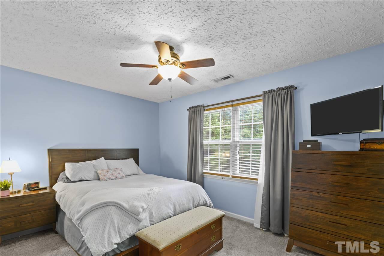 7050 Jeffreys Creek Lane Raleigh, NC 27616 - Photo 13 of 23 a bedroom with a bed and a flat screen tv