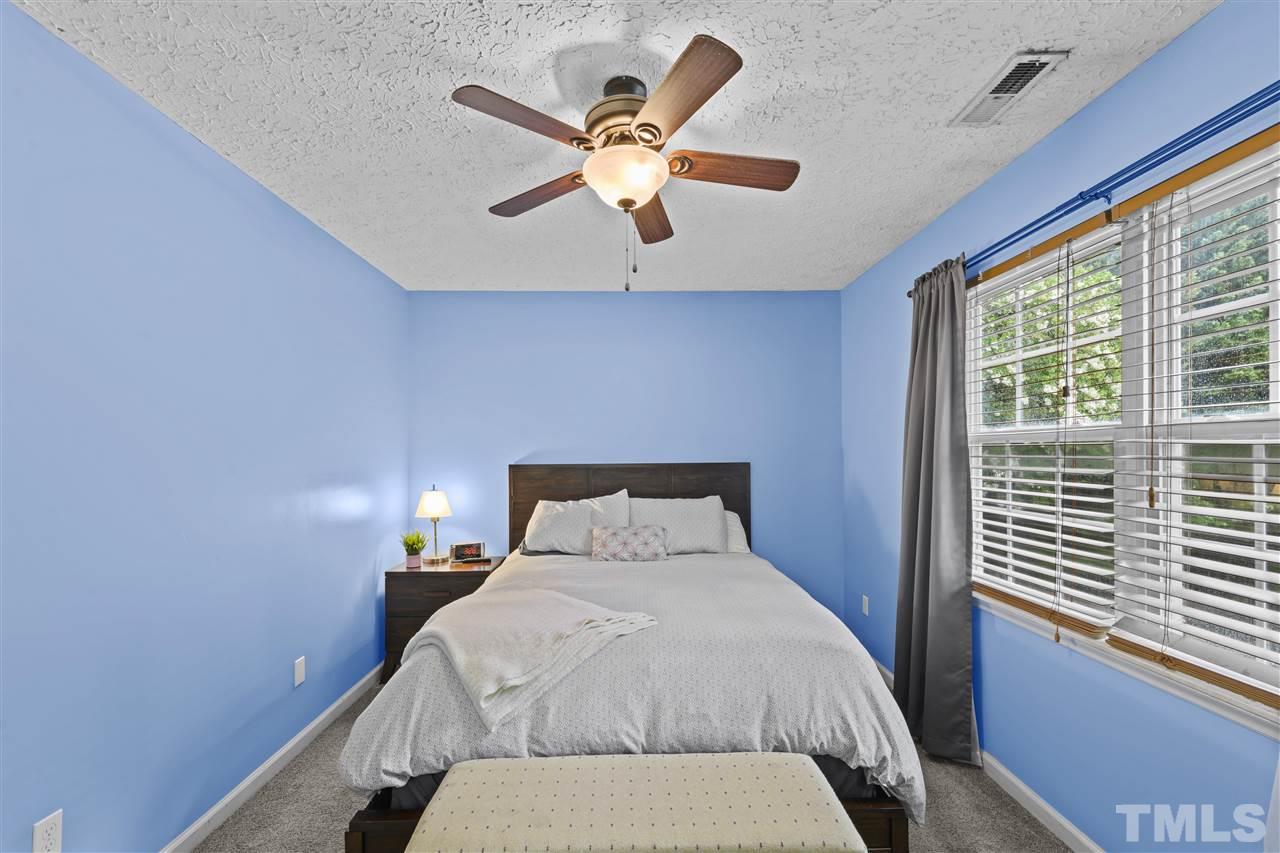 7050 Jeffreys Creek Lane Raleigh, NC 27616 - Photo 14 of 23 a bedroom with a bed and window