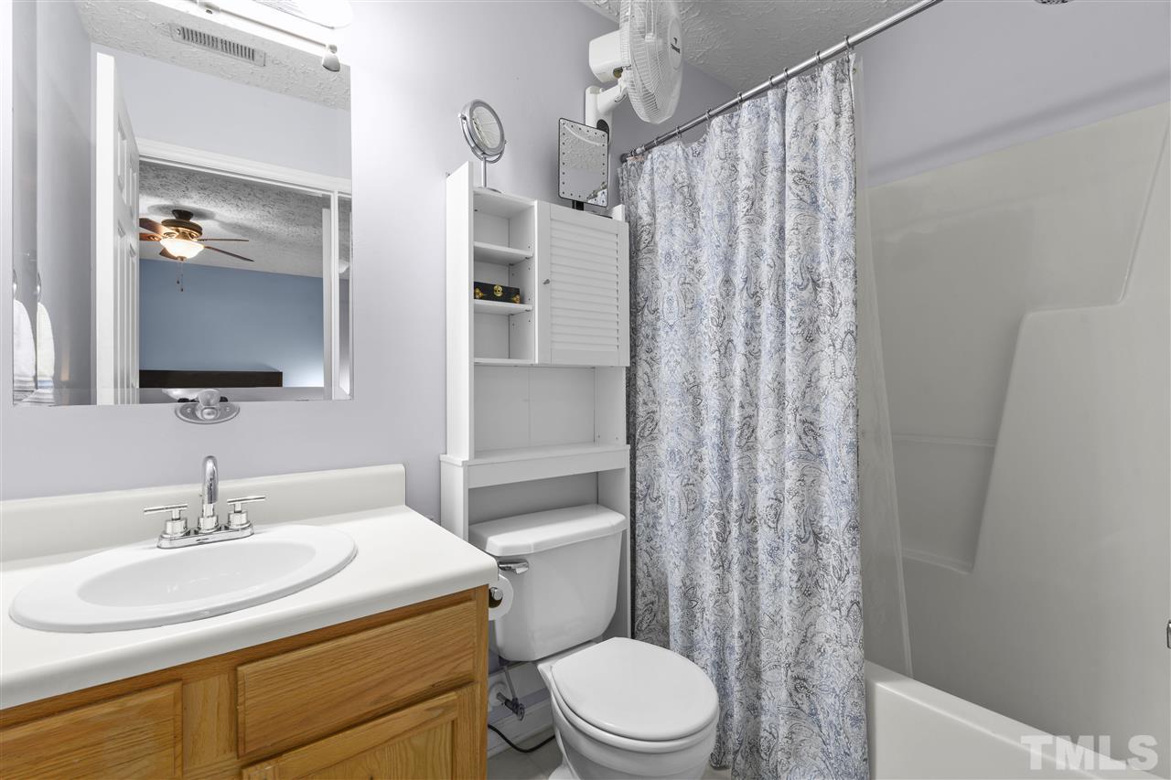 7050 Jeffreys Creek Lane Raleigh, NC 27616 - Photo 15 of 23 a bathroom with a sink toilet a mirror and shower curtain