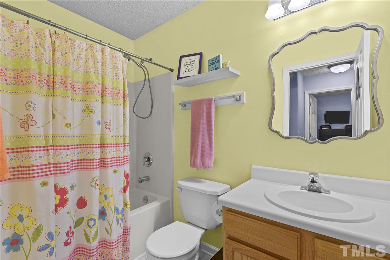 7050 Jeffreys Creek Lane Raleigh, NC 27616 - Photo 18 of 23 a bathroom with a sink vanity mirror and toilet