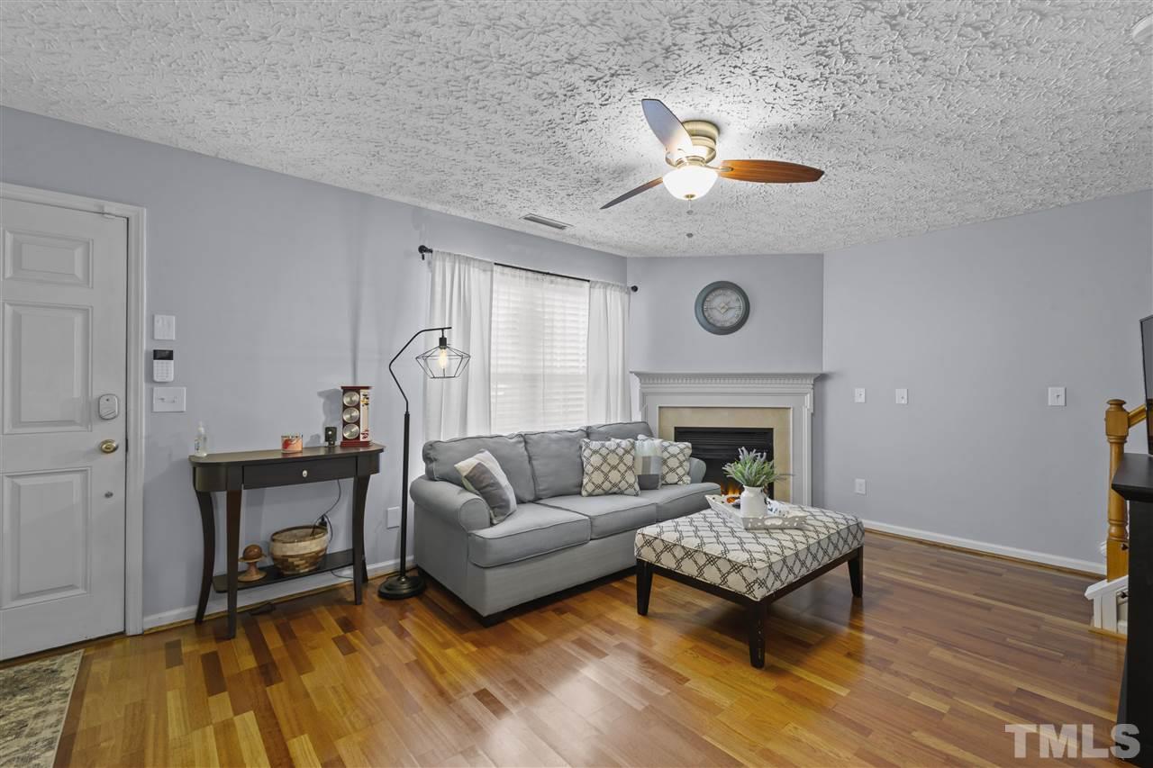 7050 Jeffreys Creek Lane Raleigh, NC 27616 - Photo 3 of 23 a living room with furniture and a fireplace