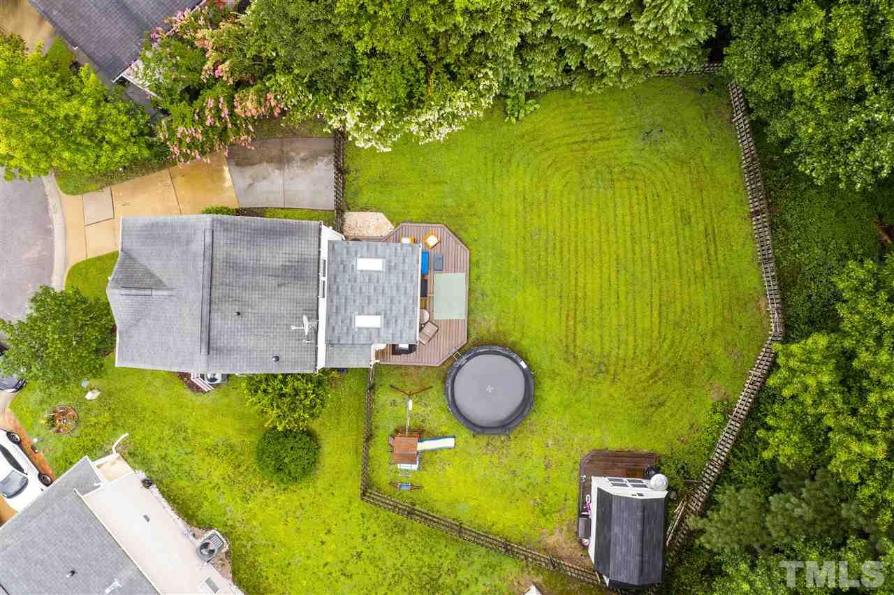 7050 Jeffreys Creek Lane Raleigh, NC 27616 - Photo 22 of 23 a view of a back yard of the house with a swimming pool