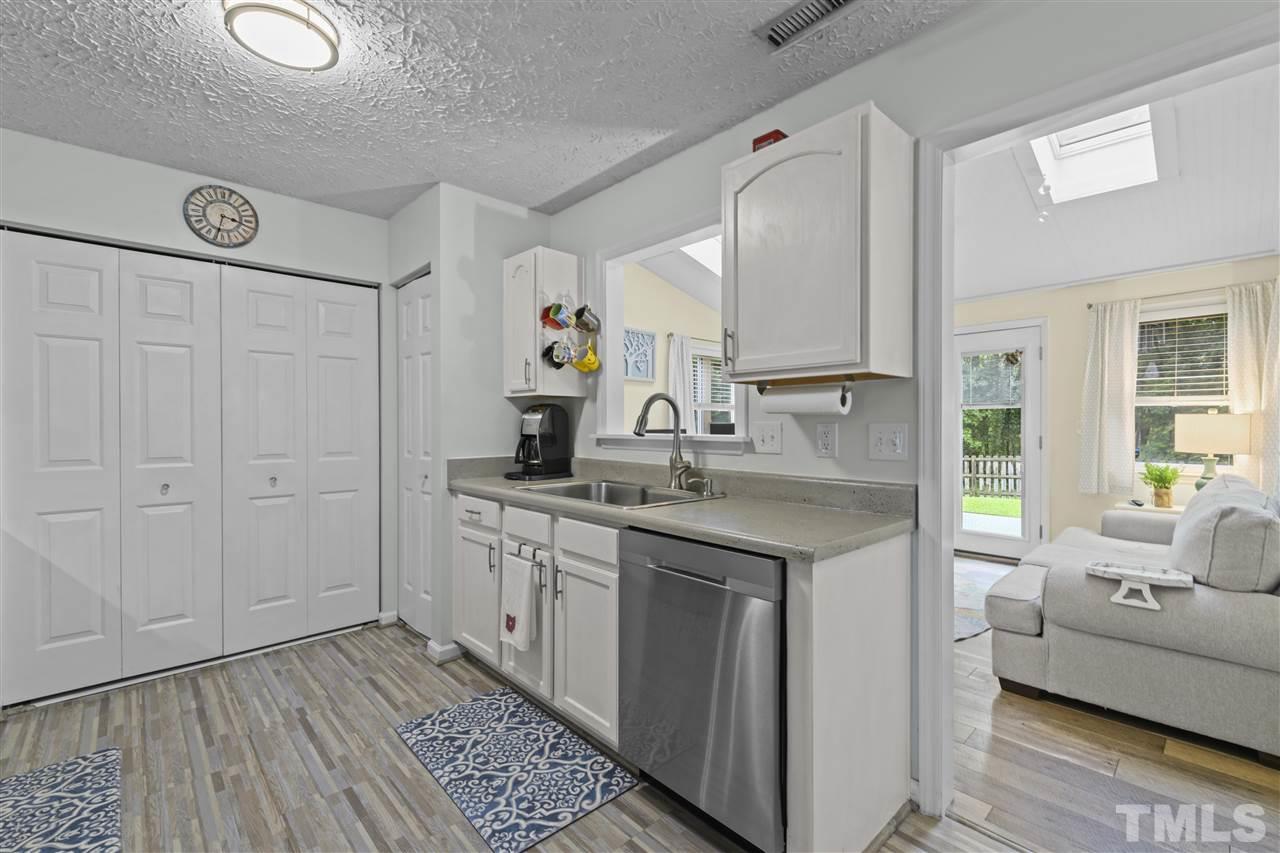 7050 Jeffreys Creek Lane Raleigh, NC 27616 - Photo 5 of 23 a kitchen with a sink cabinets and wooden floor