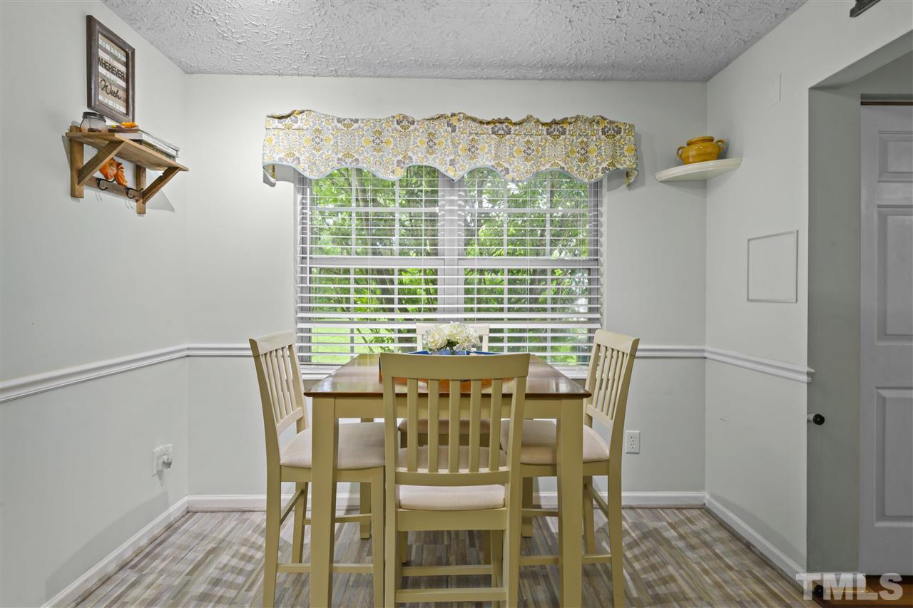 7050 Jeffreys Creek Lane Raleigh, NC 27616 - Photo 9 of 23 a view of a dining room with furniture and wooden floor