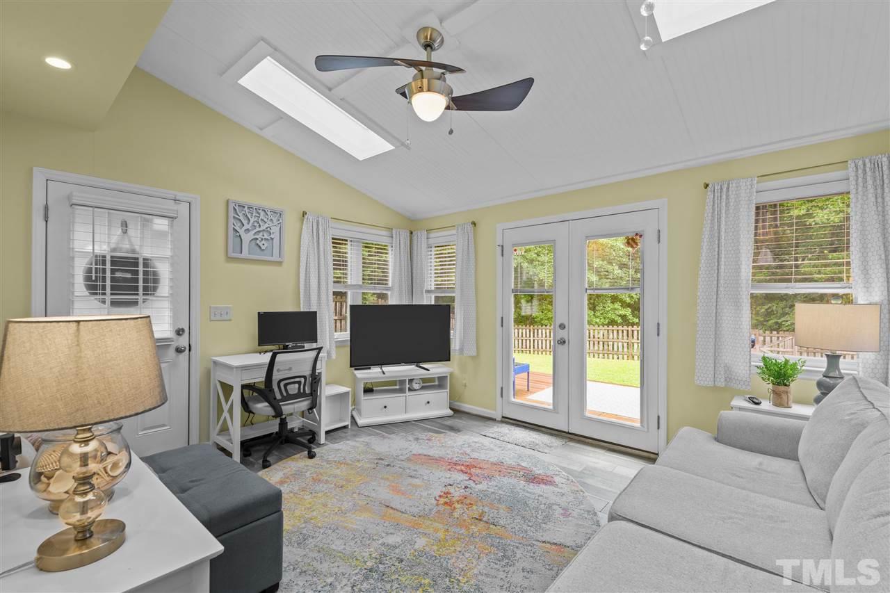 7050 Jeffreys Creek Lane Raleigh, NC 27616 - Photo 10 of 23 a living room with furniture a flat screen tv and a window