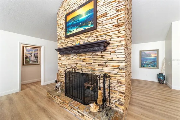 a kitchen with stainless steel appliances granite countertop a stove top oven a sink a dining table and chairs