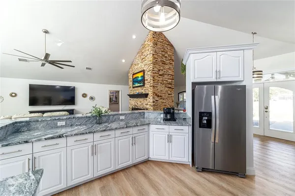 a spacious bathroom with a granite countertop shower a toilet and a sink