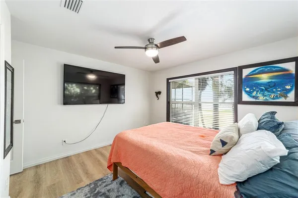 a living room with patio furniture and a floor to ceiling window