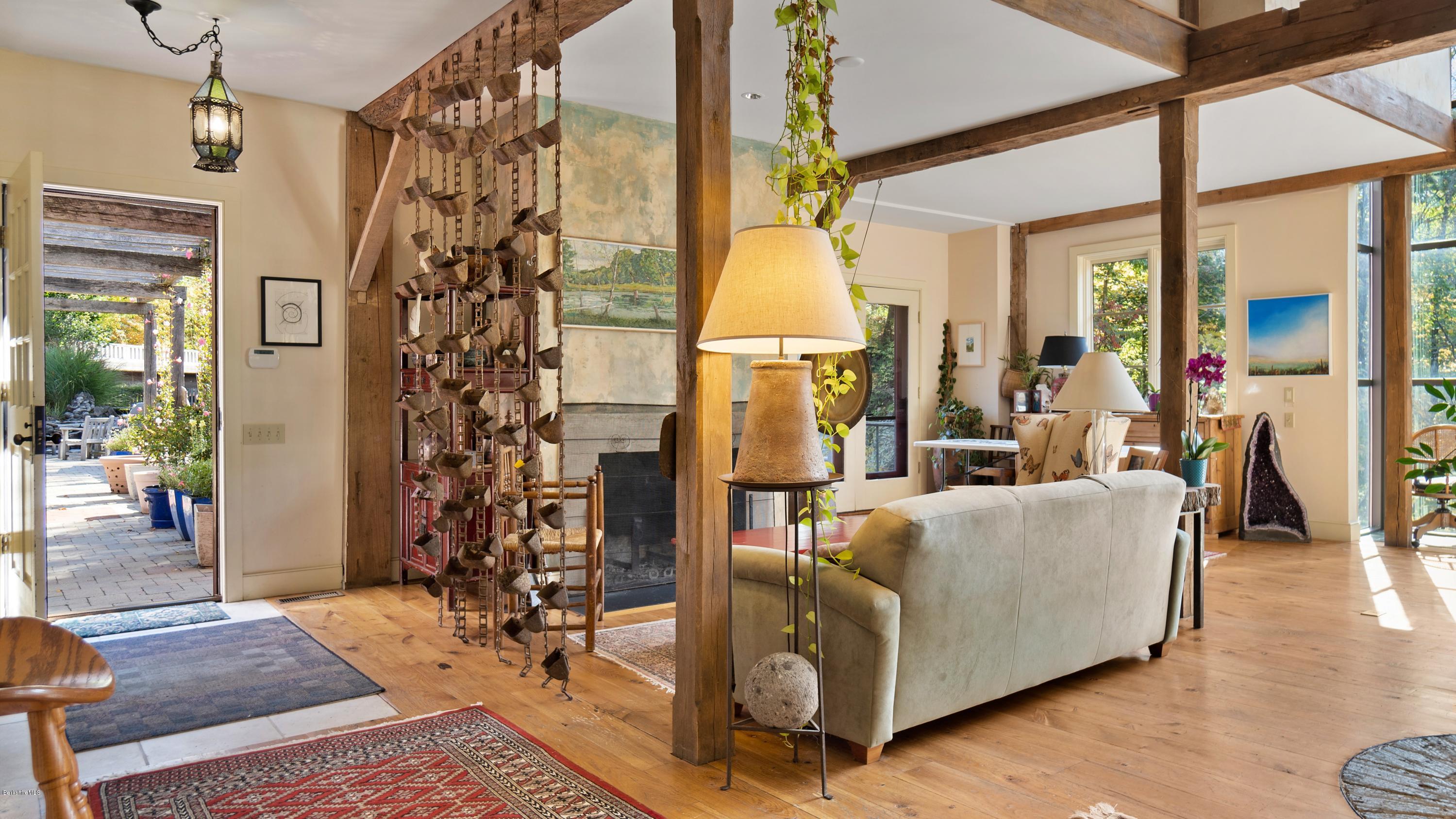 1204 Ashley Falls Road Sheffield, MA 01257 - Photo 11 of 55 a living room with a couch and a chandelier