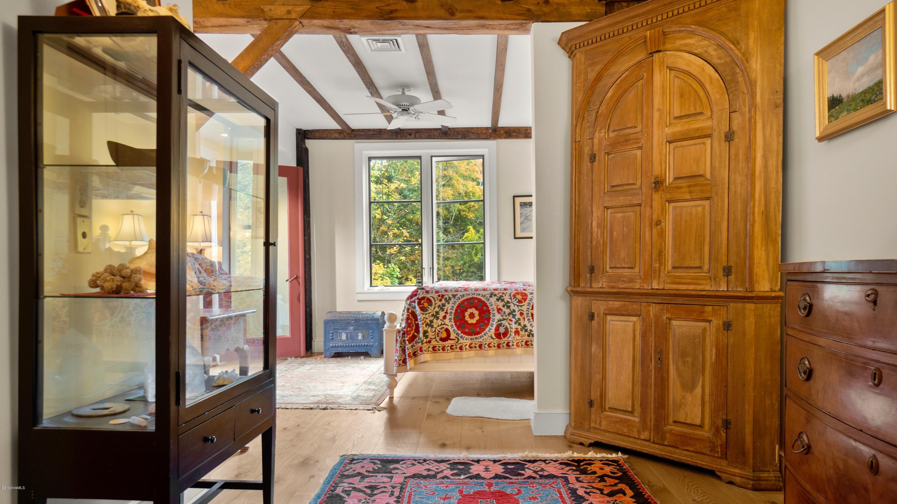 1204 Ashley Falls Road Sheffield, MA 01257 - Photo 16 of 55 a bedroom with a bed and a dresser with wooden floor
