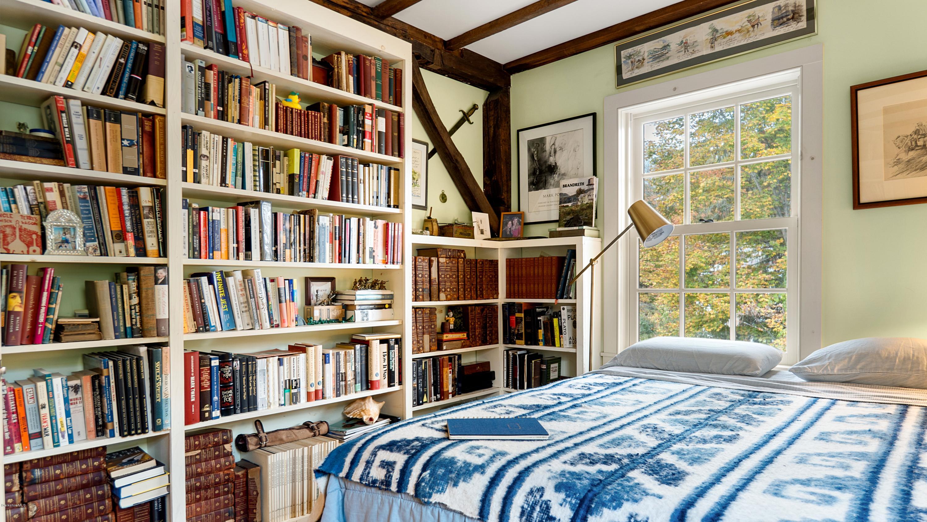 1204 Ashley Falls Road Sheffield, MA 01257 - Photo 26 of 55 a bedroom with a large bed and a book shelf