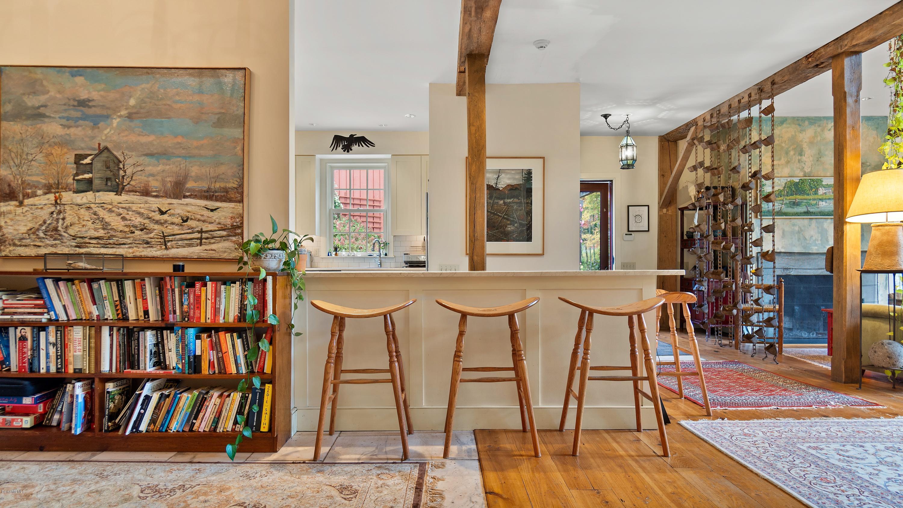 1204 Ashley Falls Road Sheffield, MA 01257 - Photo 10 of 55 a dining room with furniture and a book shelf