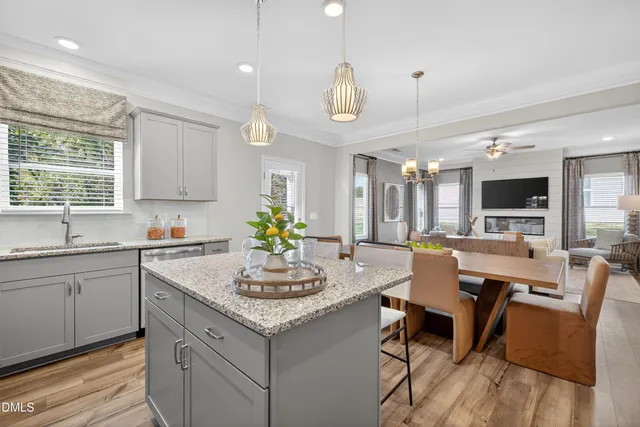 a kitchen with a dining table cabinets and stainless steel appliances