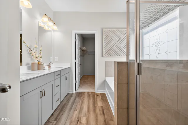 a spacious bathroom with a double vanity sink and mirror