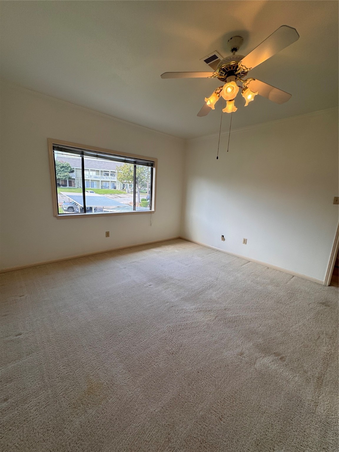 134 April Point Drive South Conroe, TX 77356 - Photo 11 of 31 an empty room with a chandelier fan and windows