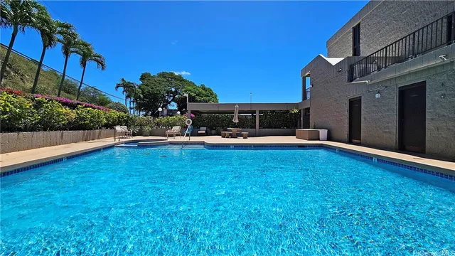 a swimming pool with outdoor seating and yard