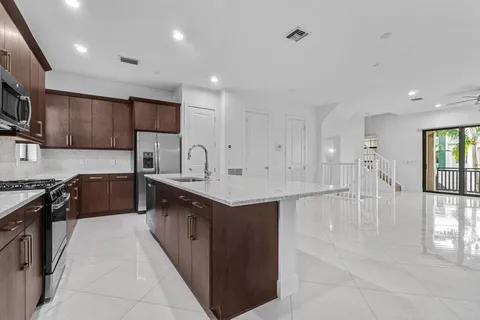 a large kitchen with stainless steel appliances lots of counter top space
