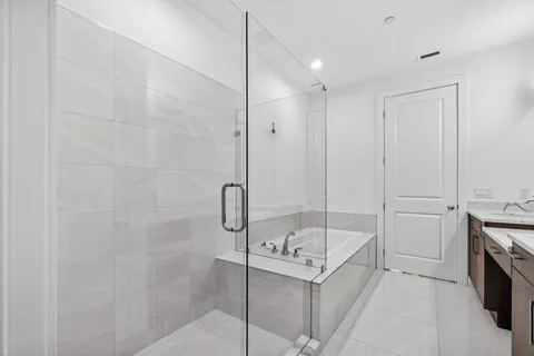 a bathroom with a bathtub and a shower