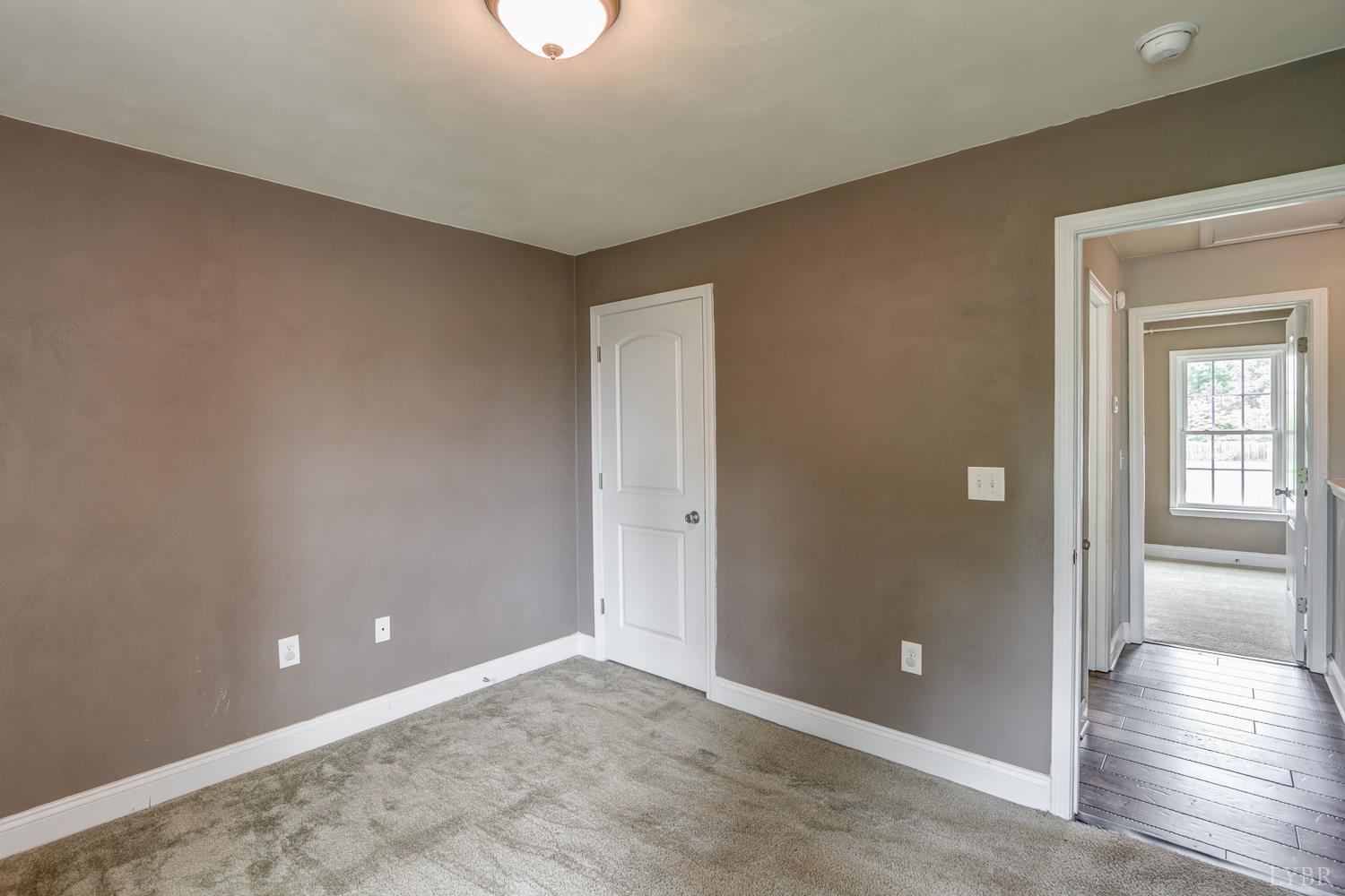 1057 Old Trail Road Forest, VA 24551 - Photo 43 of 49 an empty room with wooden floor and windows