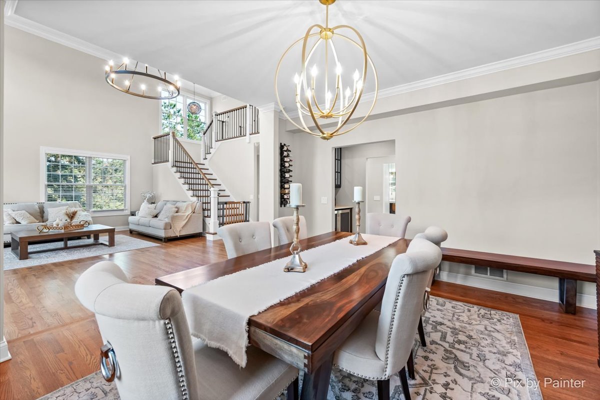 36W575 Bristol Road St. Charles, IL 60175 - Photo 11 of 58 a dining room with wooden floor a chandelier a wooden table and chairs