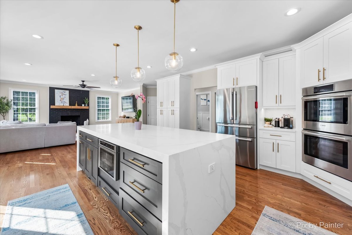 36W575 Bristol Road St. Charles, IL 60175 - Photo 15 of 58 a kitchen with stainless steel appliances a stove a sink a microwave a refrigerator a stove top oven and a center island