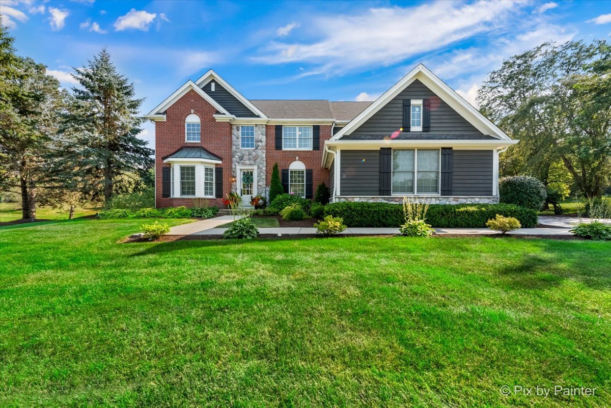 36W575 Bristol Road St. Charles, IL 60175 - Photo 3 of 58 a front view of a house with a yard and potted plants