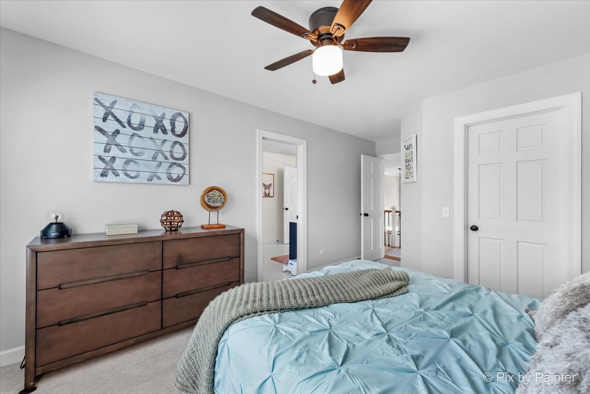 36W575 Bristol Road St. Charles, IL 60175 - Photo 32 of 58 a bedroom with a bed and a chandelier