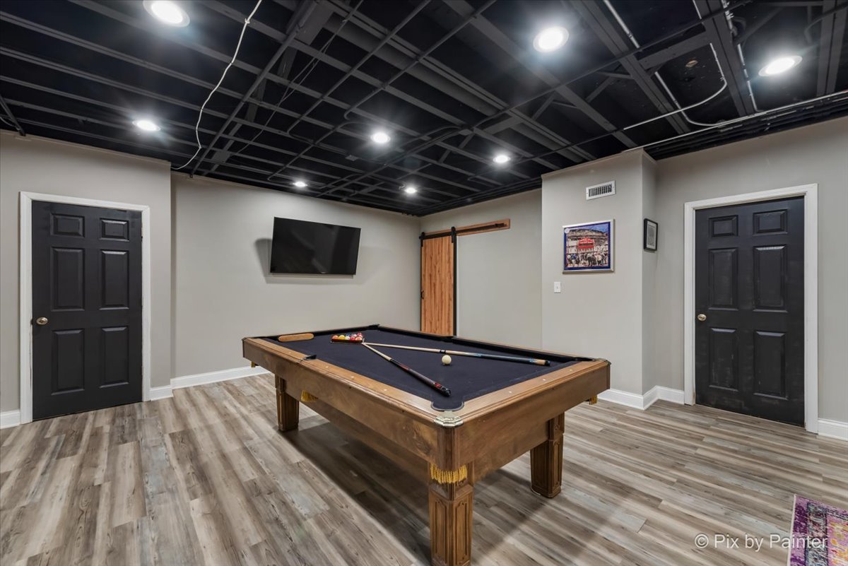 36W575 Bristol Road St. Charles, IL 60175 - Photo 40 of 58 a room with wooden floor pool table and flat screen tv
