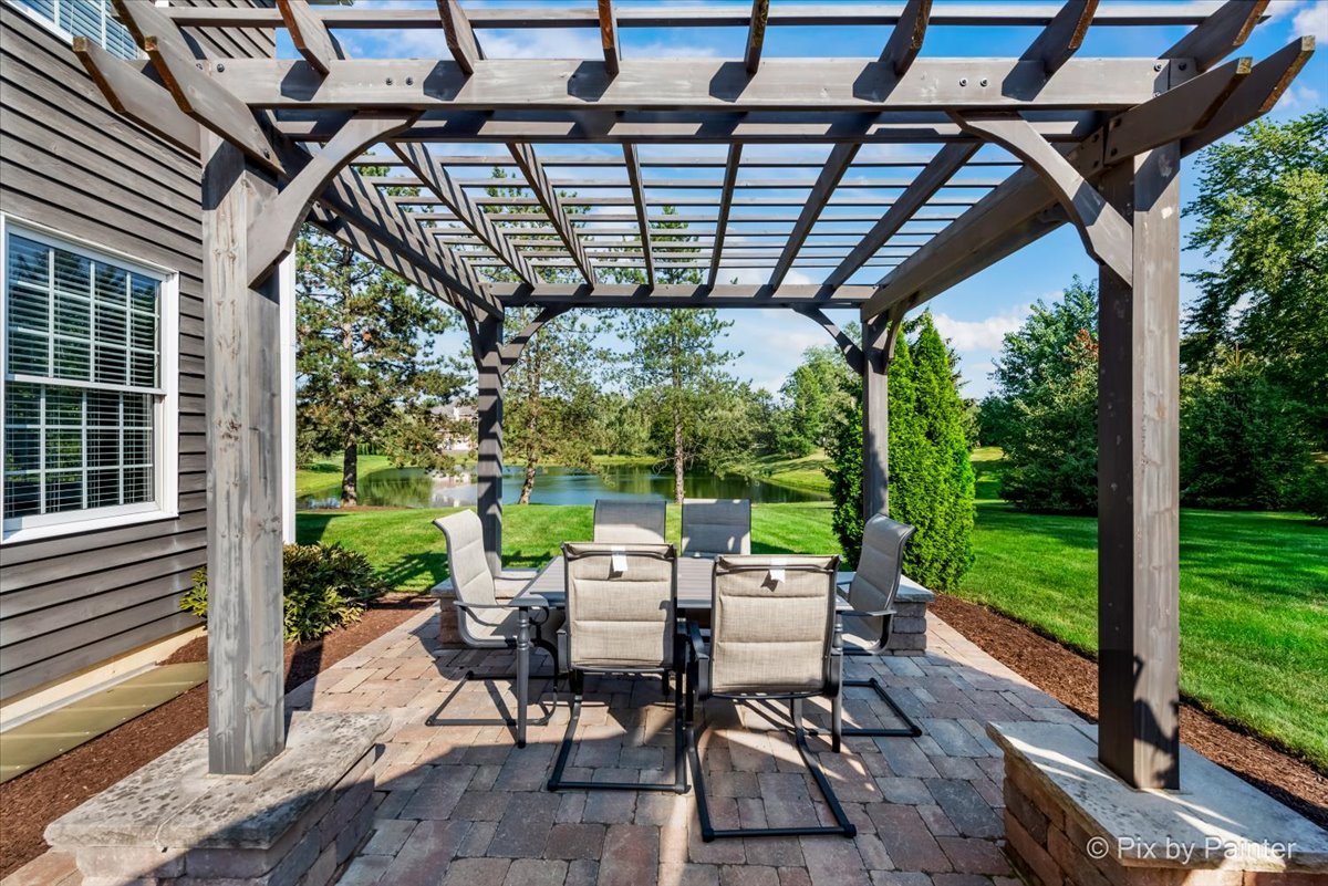 36W575 Bristol Road St. Charles, IL 60175 - Photo 48 of 58 a view of a patio with table and chairs potted plants with wooden floor and fence