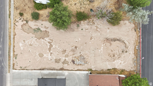 388 Wasatch Street Midvale, UT 84047 - Photo 9 of 13 Cleared lot featuring visible soil and scattered vegetation