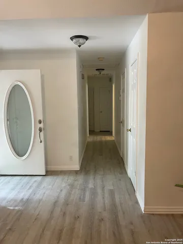 a view of a room with wooden floor and window