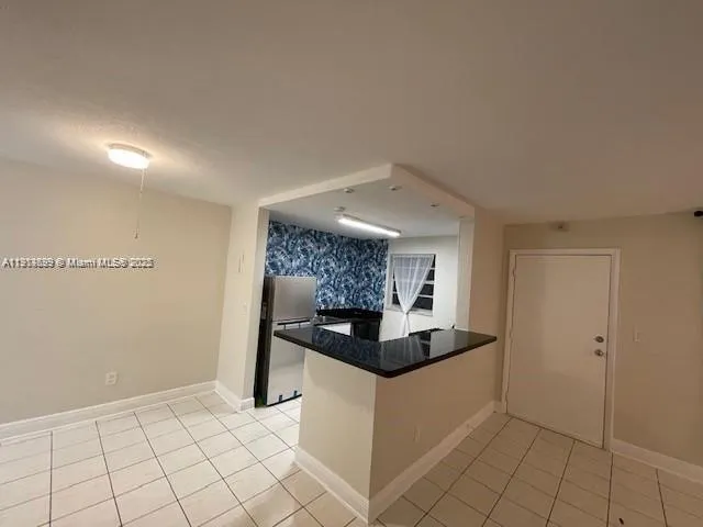 a kitchen with granite countertop a sink and a stove top oven