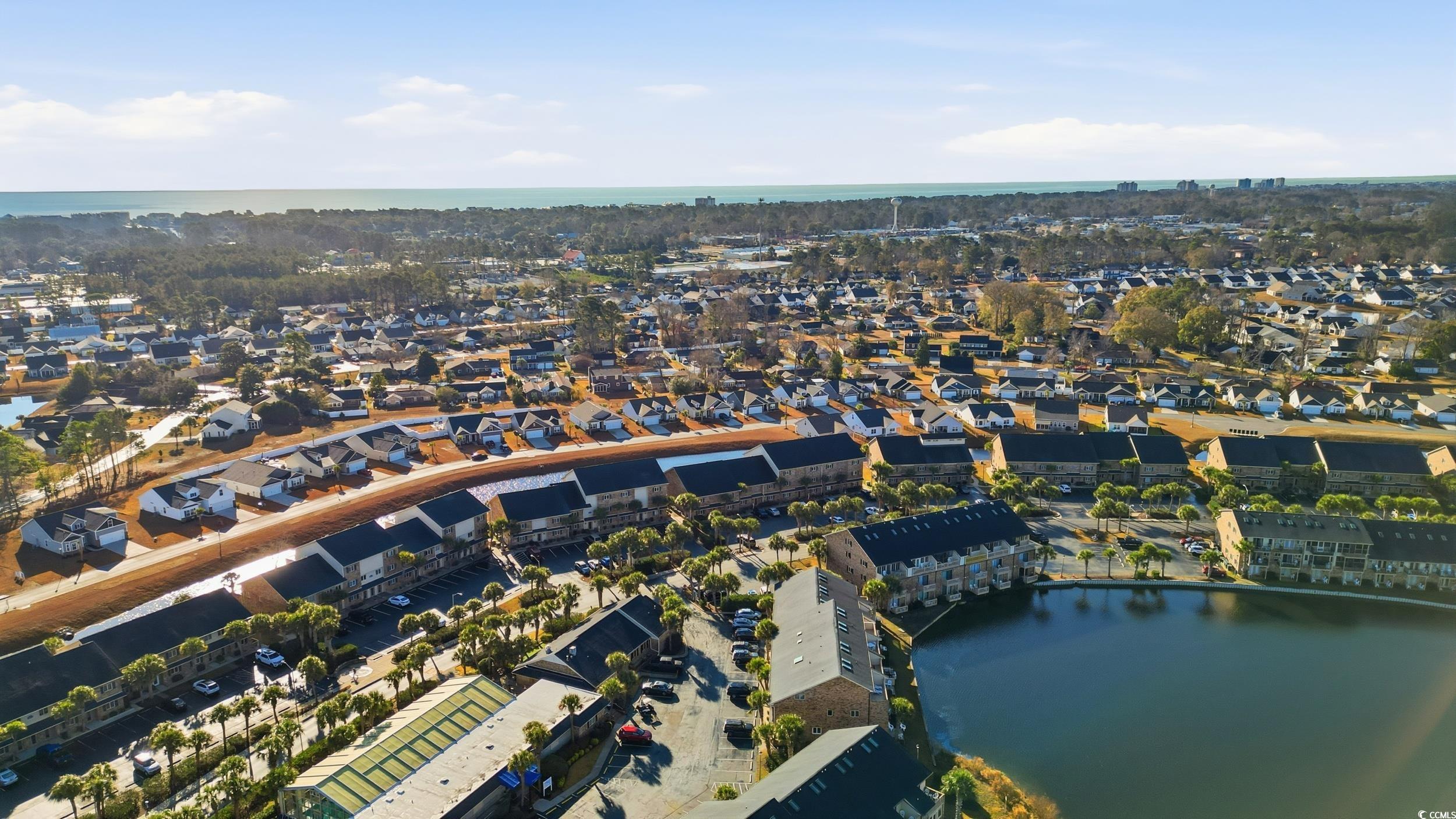 202 Double Eagle Drive, Unit C3 Surfside Beach, SC 29575 - Photo 15 of 20 Aerial view of property's location with a large body of water and nearby suburban area