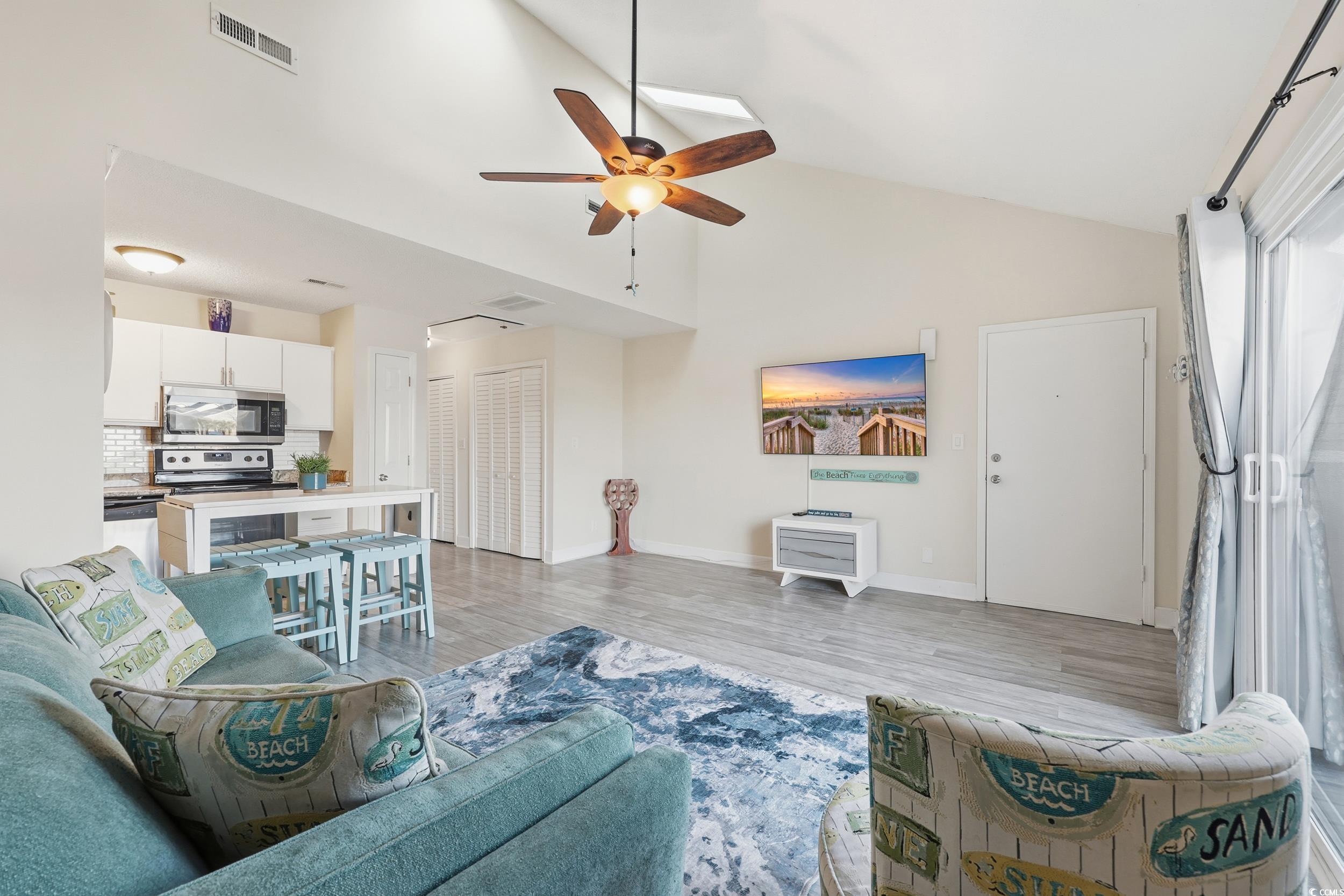 202 Double Eagle Drive, Unit C3 Surfside Beach, SC 29575 - Photo 8 of 20 Living area with ceiling fan, light wood finished floors, and high vaulted ceiling