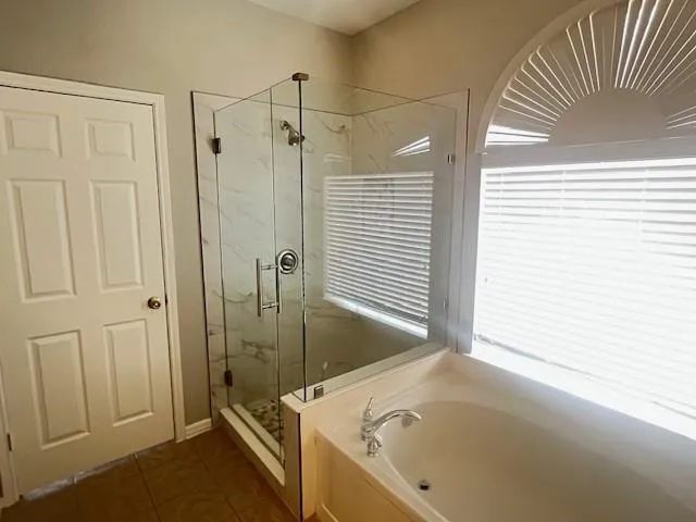a bathroom with a tub and a shower