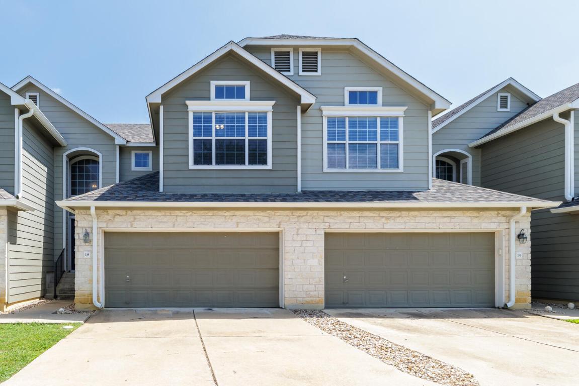 View of front facade featuring roof with shingles, driveway, and an attached garage